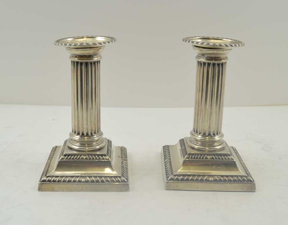 HAWKSWORTH, EYRE & CO. LTD A PAIR OF CLASSICAL COLUMN DESIGN SILVER CANDLESTICKS, with removable