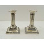 HAWKSWORTH, EYRE & CO. LTD A PAIR OF CLASSICAL COLUMN DESIGN SILVER CANDLESTICKS, with removable