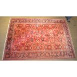 A LATE 20TH CENTURY PERSIAN DESIGN WOVEN WOOL FLOOR CARPET having pigeon red ground central busy