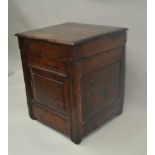 AN OAK HINGED LIDDED BOX, assembled from early 18th century panels, 41cm x 39cm x 48cm high
