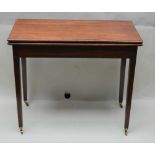 A 19TH CENTURY MAHOGANY FOLDOVER TEA TABLE, rectangular top on squared tapering supports with