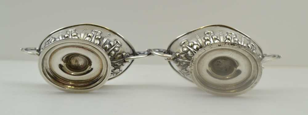 NATHAN & HAYES A PAIR OF SILVER SALTS, boat form with two handles, repousse decoration on oval - Image 2 of 4