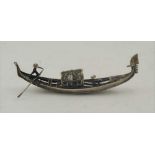 AN EARLY 20TH CENTURY ITALIAN WHITE METAL MODEL OF A GONDOLA, with hinged compartment, 15cm long