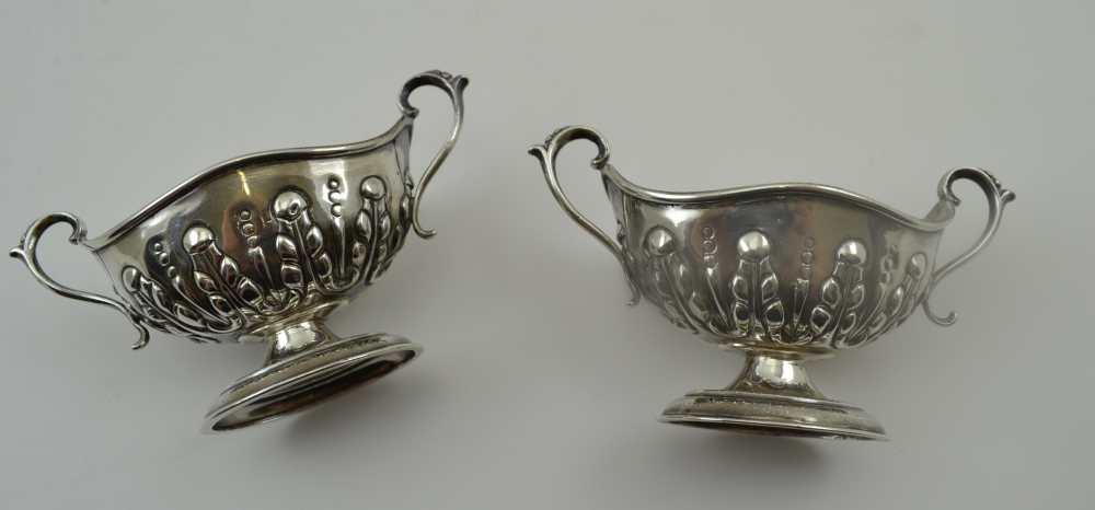 NATHAN & HAYES A PAIR OF SILVER SALTS, boat form with two handles, repousse decoration on oval - Image 4 of 4