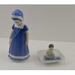 A BING & GRONDAHL DANISH CERAMIC FIGURE OF A GIRL IN A BLUE DRESS & BONNET, factory marks to base