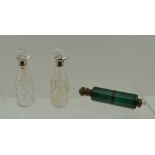 A PAIR OF VICTORIAN CONDIMENT BOTTLES, facet cut glass with silver, double pouring lip mounts,