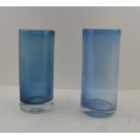 TWO 'KING'S LYNN' BLUE TINTED GLASS VASES of cylindrical form, (c.1967/69) both with ground pontils,