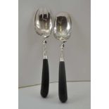 A PAIR OF WHITE METAL SALAD SERVERS, pierced and engraved leaf decoration, horn pistol grip handles,