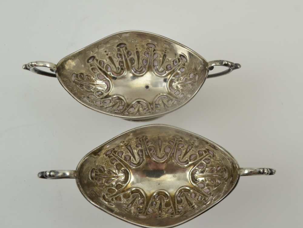 NATHAN & HAYES A PAIR OF SILVER SALTS, boat form with two handles, repousse decoration on oval - Image 3 of 4