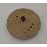 A INCISED STONE DIVINATION DISC, with central bronze handle and bronze studs to both