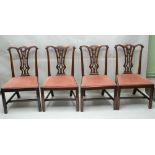 A SET OF FOUR GEORGIAN DESIGN MAHOGANY SINGLE DINING CHAIRS, pierced and carved splats with fabric