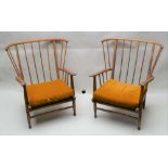 A PAIR OF MID-CENTURY ELM & BEECH STICK BACK WING ARMCHAIRS in the manner of Ercol, having