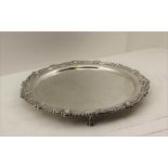 FRANK COBB & CO. LTD A GEORGIAN DESIGN SILVER SALVER with decorative rim, raised on three ball &