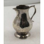 A GEORGIAN SILVER SPARROW BEAK CREAM JUG, baluster body with 'C' scroll handle on raised circular