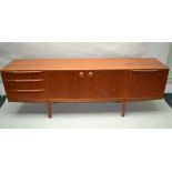 A McINTOSH BRANDED TEAK LONG AND LOW SIDEBOARD, having a combination of cupboard doors, drawers