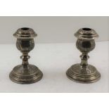 A PAIR OF PERSIAN SILVER CANDLESTICKS, overall chased decoration, bear various stamped marks, c.
