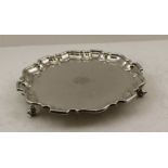 EMILE VINER A GEORGIAN DESIGN SILVER SALVER, pie crust rim, raised on three scroll supports,