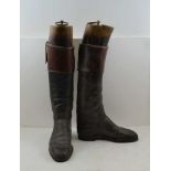 A PAIR OF BLACK LEATHER, TAN TOP HUNTING / RIDING BOOTS with wooden trees