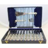 A CASED CANTEEN OF FISH SERVERS, together with twelve fish eating knives and ten fish eating