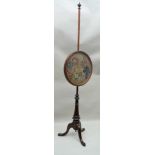 A 19TH CENTURY MAHOGANY POLE SCREEN, raised on triform base, fitted a circular framed panel, with