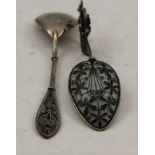 TWO PIQUE A JOUR ENAMEL DECORATED CONTINENTAL SPOONS one with scrolling floral mounted handle (2)