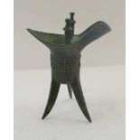 A CHINESE BRONZE 'JUE' CUP, Shang type on tripod supports, single side handle, decoratively