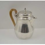 WILLIAM COMYNS & SONS LTD AN EARLY 20TH CENTURY SILVER LIDDED HOT WATER / MILK JUG with cane bound