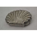 A LATE 19TH CENTURY CONTINENTAL WHITE METAL SCALLOP FORM PURSE with embossed decoration, pink fabric