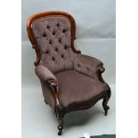 A VICTORIAN CARVED SHOW WOOD FRAMED BUTTON BACK EASY CHAIR, scroll arms on cabriole fore supports,