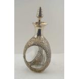 A CHINESE SILVER MOUNTED DECANTER, pierced and chased decoration of bamboo, dragon, pagoda and junk,