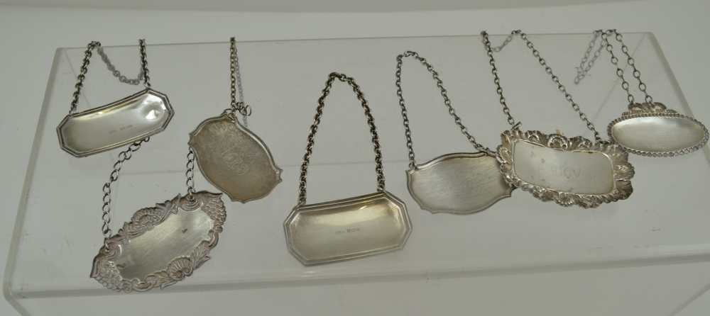 A COLLECTION OF SEVEN ASSORTED SILVER WINE & SPIRIT LABELS, various stamped shapes, with chains, - Image 4 of 4