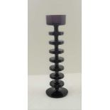 A 'KING'S LYNN' SHERRINGHAM PATTERN AMETHYST GLASS CANDLE HOLDER, of seven ring design by Ronald