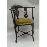 A LATE 19TH / EARLY 20TH CENTURY POSSIBLE CONTINENTAL CORNER ARMCHAIR, with fancy lattice pierced