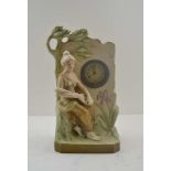 A ROYAL DUX BOHEMIA POTTERY MANTEL CLOCK, moulded and painted female figure with a mandolin, pink