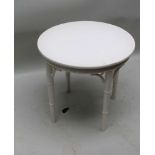 A GLOSS WHITE LACQUERED CIRCULAR TOPPED COFFEE TABLE on four faux bamboo legs, 52cm high, 56cm in