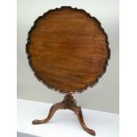 A 19TH CENTURY PIECRUST EDGED TILT TOP TABLE on turned column and three carved downswept legs,
