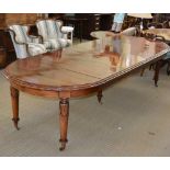 A LATE 20TH CENTURY MAHOGANY FINISHED REPRODUCTION EXTENDING DINING TABLE, wind-out circular topped,