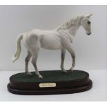 A ROYAL DOULTON MODEL OF DESERT ORCHID, Racehorse on polished wood base, 23cm high