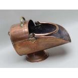 A 19TH CENTURY COPPER COAL SCUTTLE with three handles various, on a circular plinth, 31cm high to