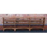 A FIRST QUARTER 20TH CENTURY LONG & LOW SET OF OPEN SHELVES, 92cm high, 282cm long