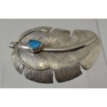 DELBERT VANDEVER A modernist sterling silver belt buckle, of feather form, inset polished turquoise,