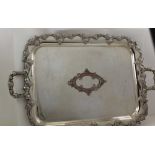 AN EARLY 20TH CENTURY SILVER PLATE ON COPPER TWO-HANDLED TEA TRAY, with cast fruiting vine rim and