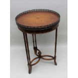 A THEODORE ALEXANDER REPRODUCTION CIRCULAR TOPPED OCCASIONAL TABLE with pierced gallery, supported