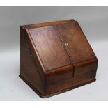 A 19TH CENTURY WALNUT FINISHED STATIONARY BOX, with twin opening, doors to reveal