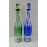 TWO LATE VICTORIAN BOTTLE DECANTERS, one overlaid and slice cut cobalt blue, the other green, with