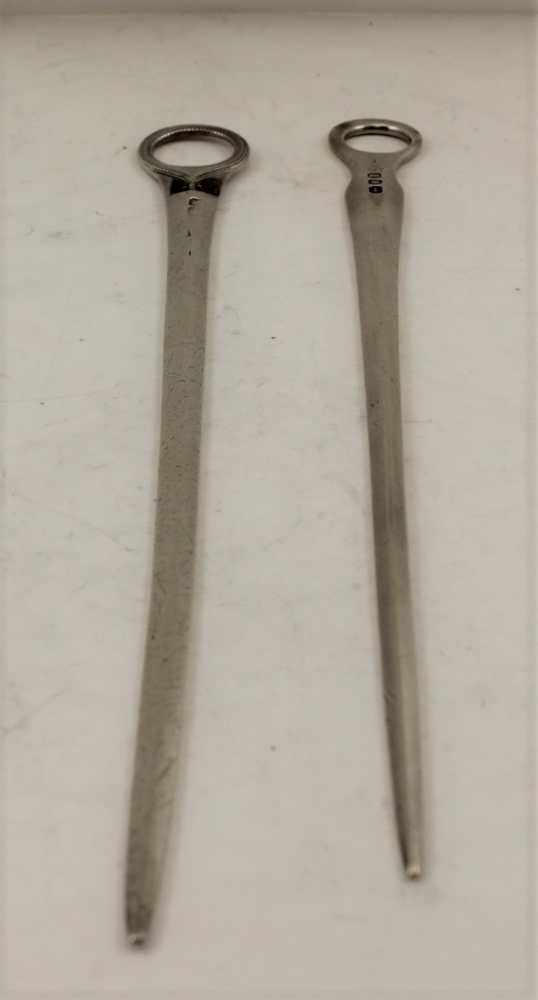 TWO GEORGE III SILVER MEAT SKEWERS, both with ring handles, one London 1804, the longest 31.5cm,