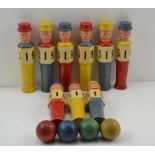 AN EARLY TO MID 20TH CENTURY SKITTLE GAME, comprising nine painted wood skittles in the form of