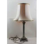 A PLATED CORINTHIAN DESIGN TABLE LAMP, raised on square stepped base, 36.5cm high (from the top of