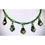 A FIN DE SIECLE DESIGN SWAROVSKI CRYSTAL NECKLACE, five absinthe tint facet cut droppers on