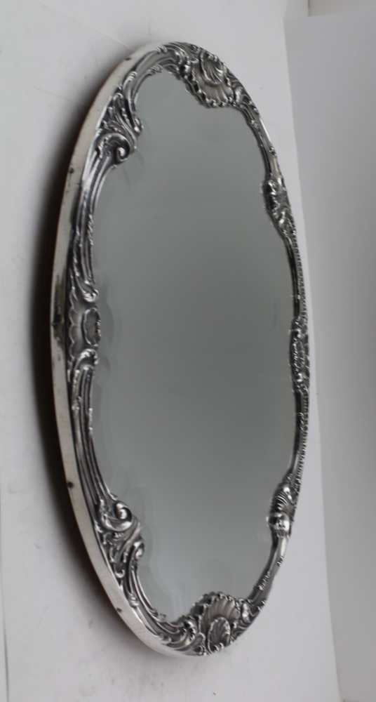 A STERLING SILVER FRAMED MIRRORED PLATEAU, the oval frame with raised acanthus leaves and